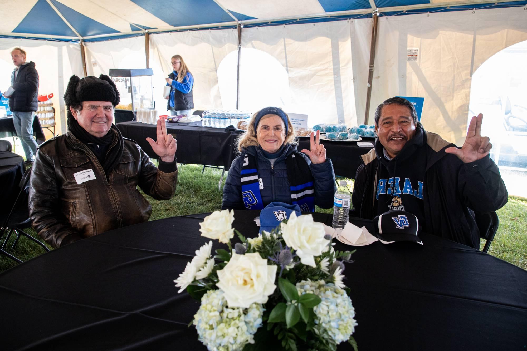 Three alums at the alumni tailgate